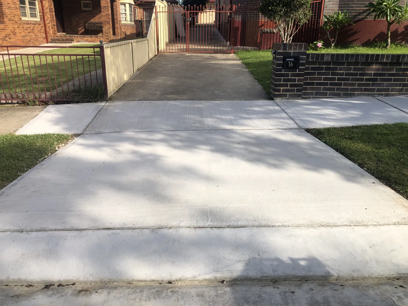 Completed concrete driveway crossover outside the Eastwood renovation project
