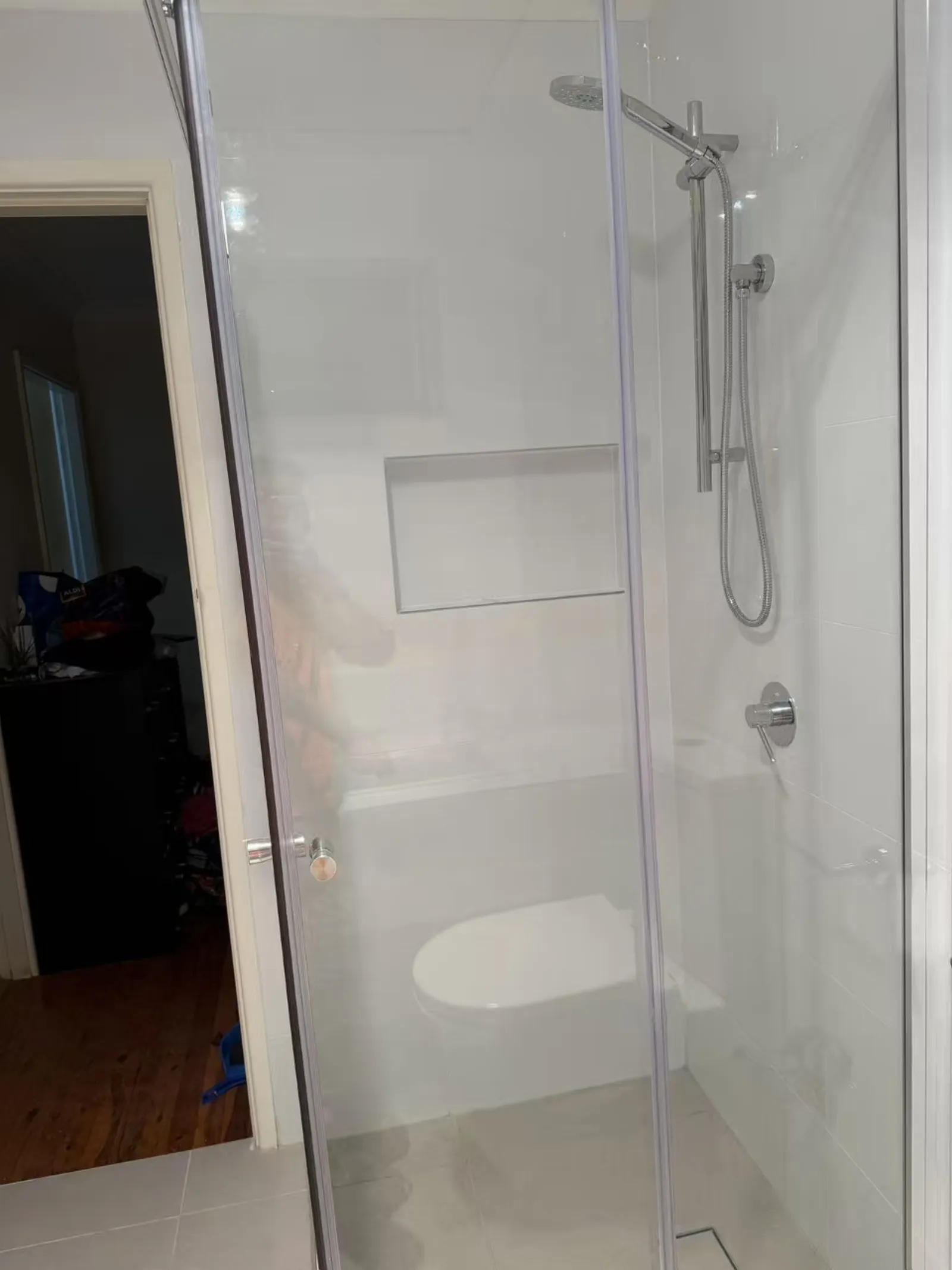 Completed Werrington bathroom with a glass shower enclosure, rainfall shower and tiled walls