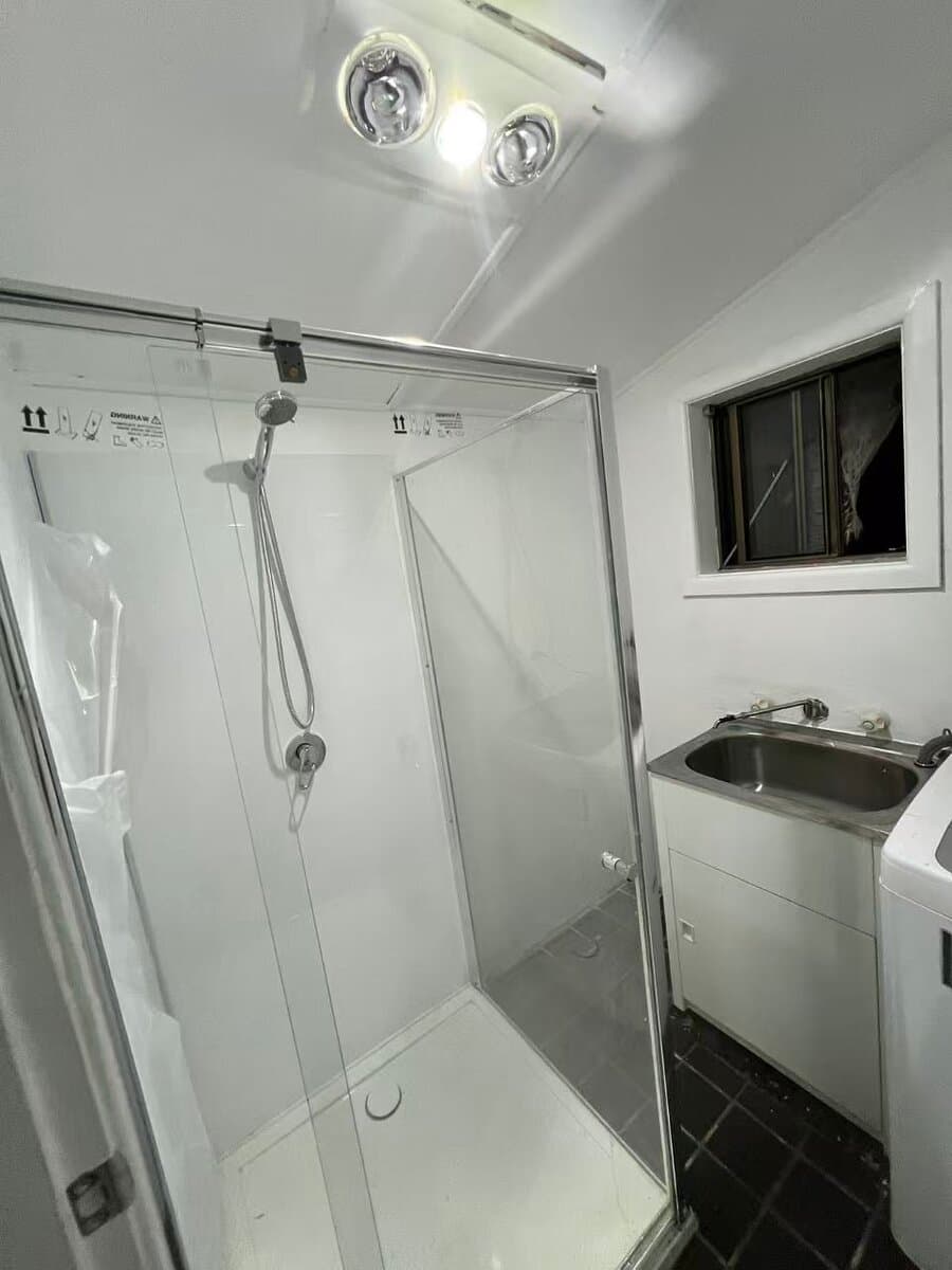 Recently completed small bathroom renovation in Sydney with frameless glass shower, laundry tub and 3-in-1 heat lamp
